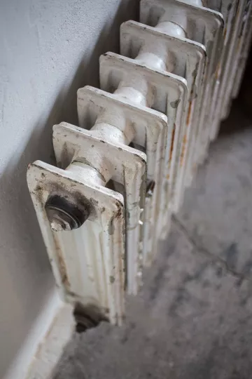 Alte Heizkörper fügen sich perfekt in die behutsam sanierten Räume ein.