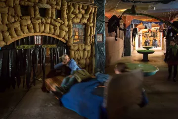 Zwei Gäste fahren auf einem der fahrenden Betten in die Unterwelt von Bimbotown.